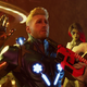 Star Lord is being held up by an unseen assailant while Gamora and Drax look on in the background.